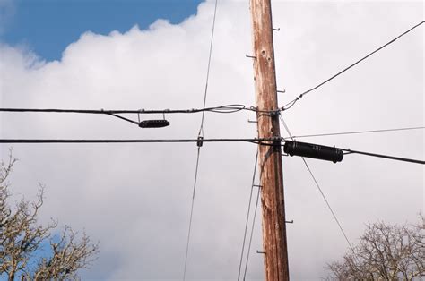 This looks trashy and annoys me to no end. . Cable line on utility pole